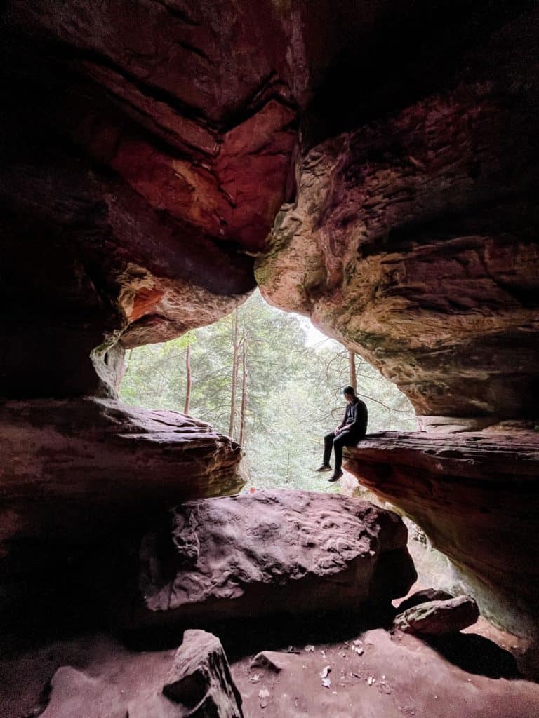 Man looking out window of Rock House in Hocking Hills