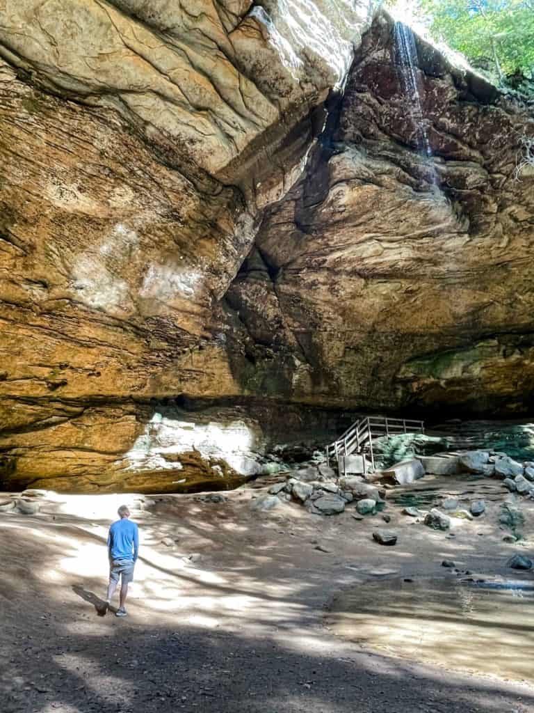 Man looking up at the waterfall at Ash Cave in Ohio