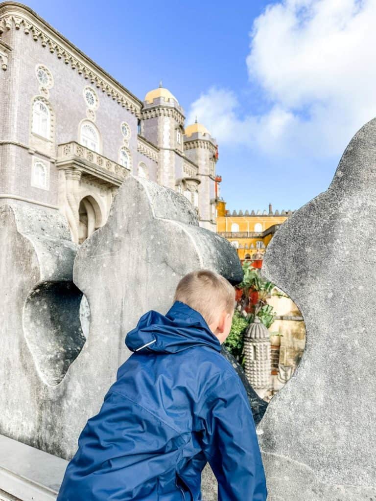 Boy looking at view from a terrace at Pena Palace, Sintra with kids is magical