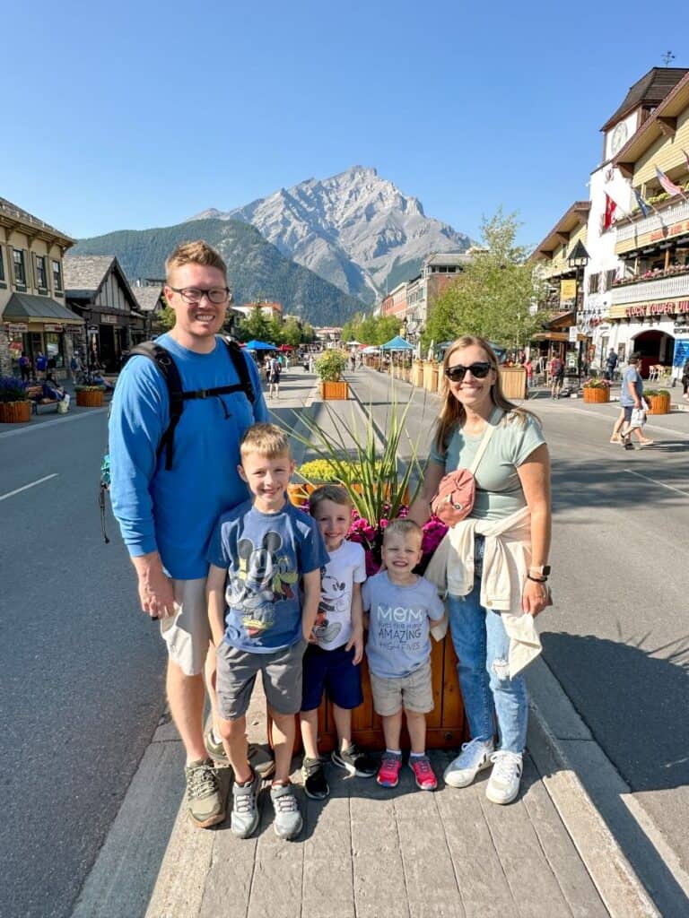 Family of 5 on Banff Avenue with mountain in background