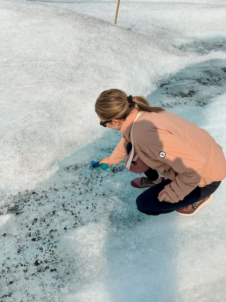 Mom filling up water bottle on the Athabasca Glacier