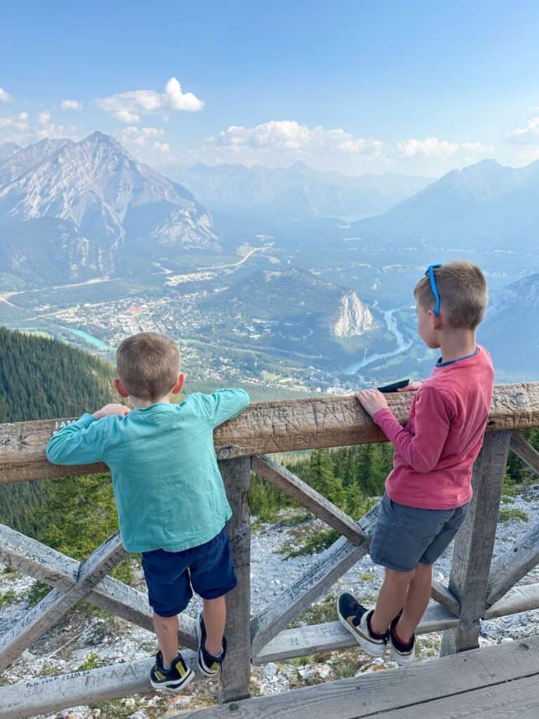 Two brothers looking at view from Sanson Peak, Sulpher Mountain in Banff