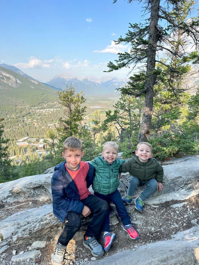 Brothers smiling on Tunnel Mountain hike with kids