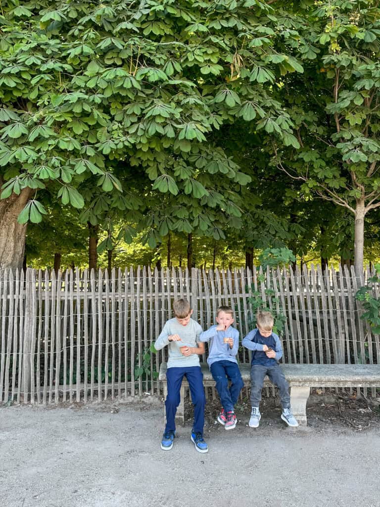 3 boys eating gelato at the Jardin des Tuileries in Paris