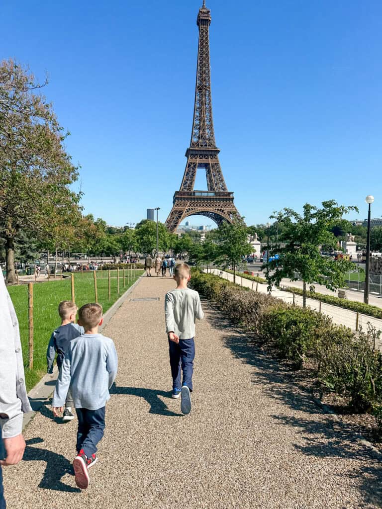 Eiffel Tower in Paris seen from the Trocadero on a sunny day with children walking in the foreground