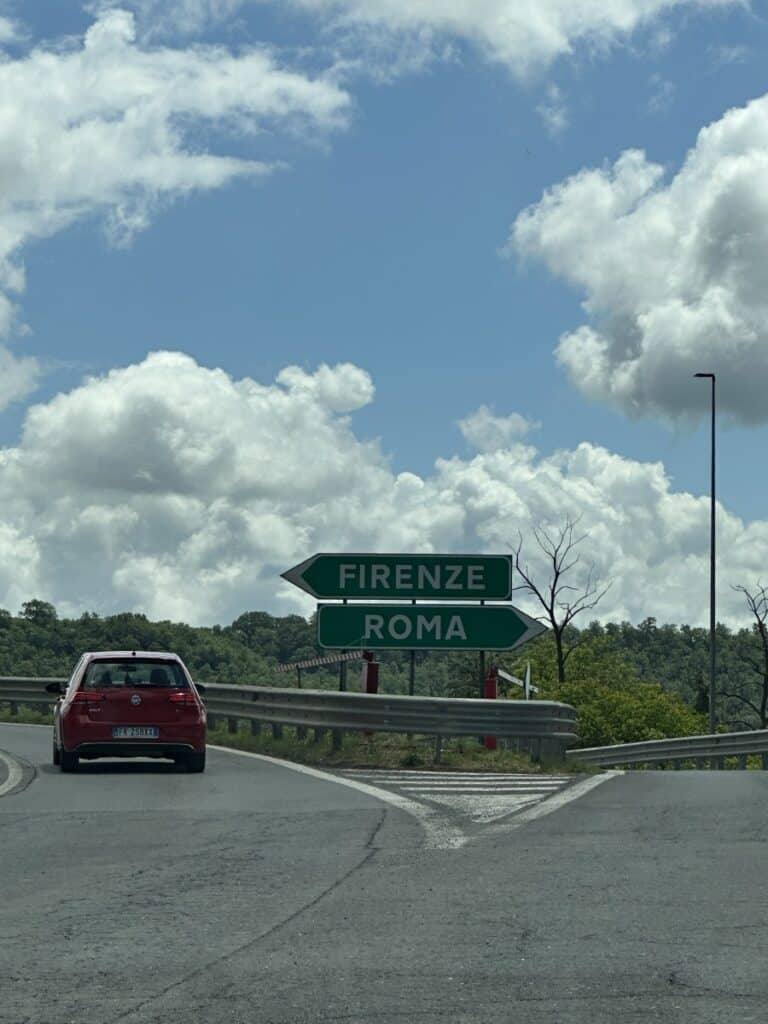 Road signs in Italy directing cars to Roma or Firenze